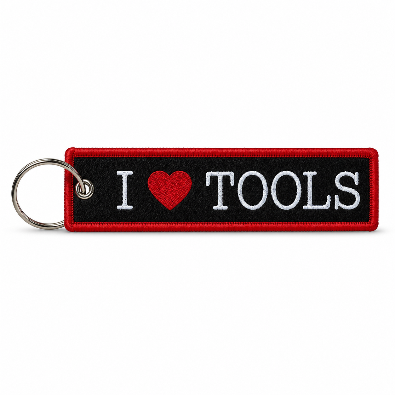 Black woven keychain tag with red border and white "I heart TOOLS" lettering with a red heart, attached to a metal split ring.
