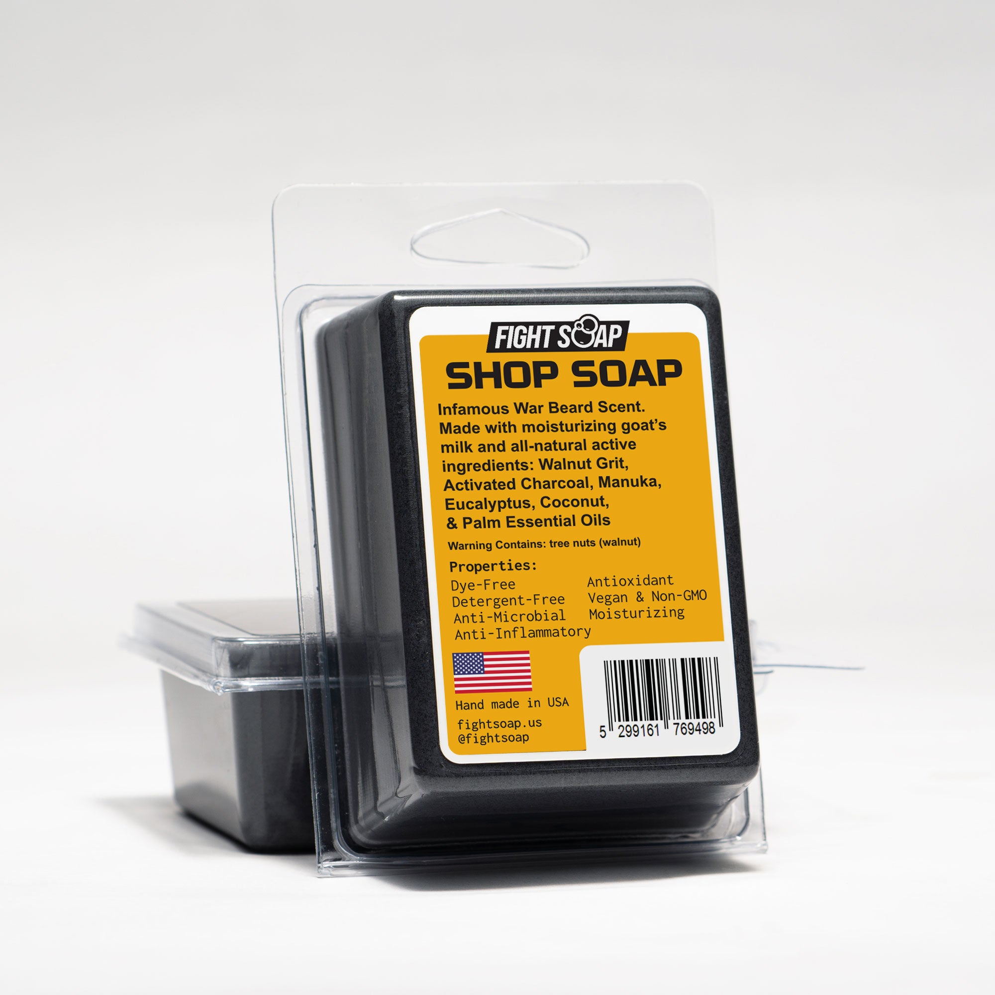 Bar of Shop Soap, a dark charcoal soap bar with visible walnut grit texture.